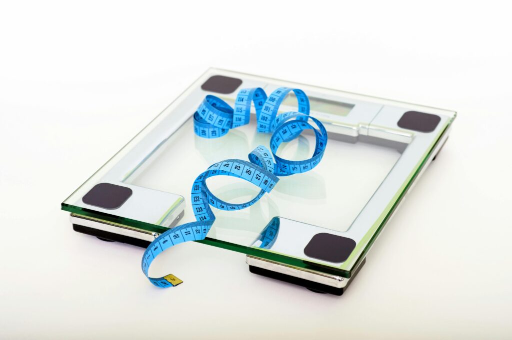 A scale and measuring tape are tools to monitor physical weight loss.
